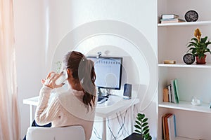 Work from home during coromavirus pandemic. Woman stays home. Workspace of freelancer. Office interior with computer