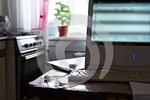 Work from home. Remote work via the Internet. Glasses and keyboard on the kitchen table