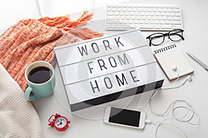 Work from home text on lightbox with working stuff