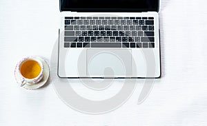 Work from home, workspace office at home, Notebook or laptop computer with Chinese tea cup  on the white desk at home office