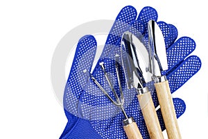 Work or household gloves and gardening tools shovel and rake on white isolated, top view, flat lay, copy space