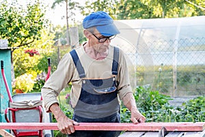 Work on the infield. Do it yourself. A carpenter processes wooden boards on the street using an electric woodworking