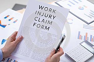 Work injury claim form concept, documents on the desktop