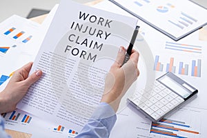 Work injury claim form concept, documents on the desktop