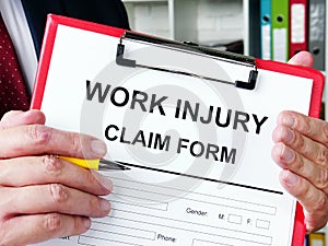 Work injury claim form is in man hands.