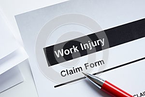 Work injury claim form and pen.