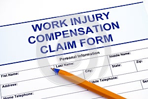 Work Injury Compensation Claim Form with pen