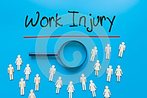 Work Injury Sign on white paper. Man Hand Holding Paper with text. Isolated on Workers concept, Magnifying glass. Blue