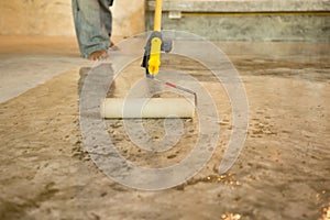 Work Lacquering concrete floors using roller for coating