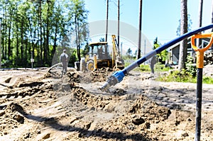 Work of a large two-wheeled tractor when laying water supply for water supply of private homes. the concept of building a country