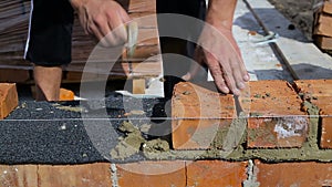 Work lays bricks on a construction site on open air