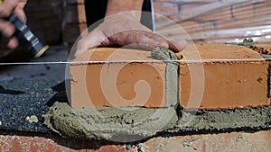 Work lays bricks on a construction site on open air