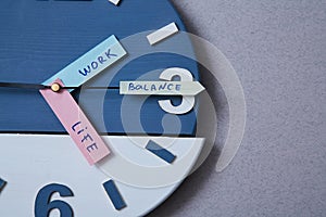 Work life balance choice concept. Clock closeup and arrows telling photo