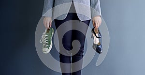 Work Life Balance Concept, present by Business Working Woman holding a High Heal and Sneaker Shoes, Croped image with Copy Space