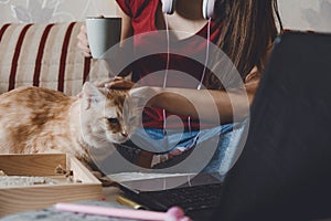 Work-life balance, Home office, work space, work from home, Flexible work hours concept. Young woman with laptop and cat