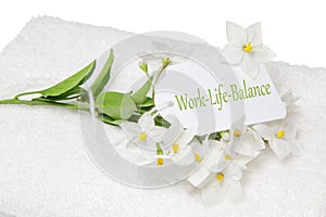 Work-Life-Balance spa decoration with white jasmine and a sign
