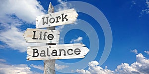 Work, life, balance - wooden signpost with three arrows