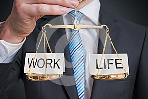 Work and life balance. Words are balanced on scales