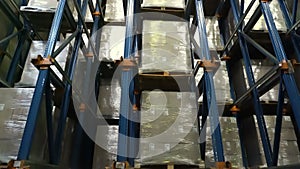 Work loaders on loading pallets with cardboard boxes on racks in a modern warehouse