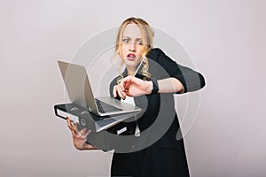 Work office busy time of blonde young woman in formal clothes with laptop, folder talking on phone on white background