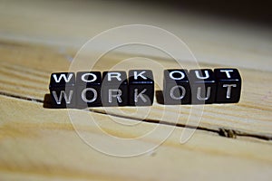 Work out written on wooden blocks. Inspiration and motivation concepts.