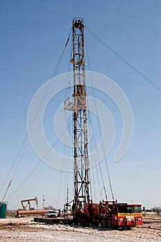 Work Over Rig, Pumpjack, and a Drilling Rig