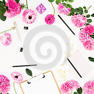 Work place with clipboard, pastel flowers and accessories on white background. Flat lay, top view. Blogger of freelancer concept w