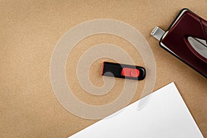 Work place top view with office supplies on textured recycled craft brown paper backdrop copy space