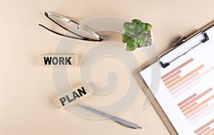 WORK PLAN text on wooden block with chart and glasses, business concept