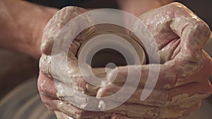 Work in the pottery workshop: clay ware on the potter`s wheel