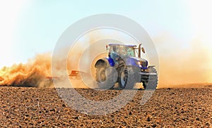 Work of a powerful tractor in field cultivation and cultivation.