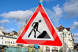 Work in progress road sign triangle isolated on cloudy background