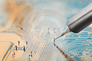 Work in progress. Soldering of electronic circuit board with electronic components. Soldering station. Engineers repair circuit bo