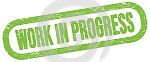 WORK IN PROGRESS, text written on green stamp sign
