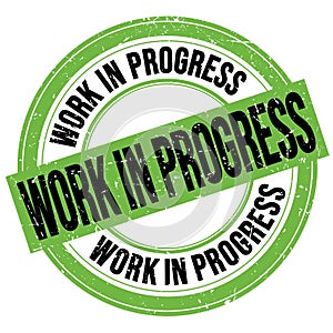WORK IN PROGRESS text written on green-black round stamp sign