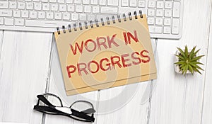 Work in Progress text written on a notebook