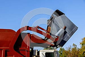 Work of public services for loading household waste from the container into the car