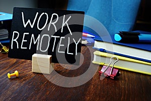 Work remotely sign on the desk about remote job photo