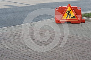 Work on road. Under construction sign. Traffic warning, yellow, orange and red colors. Street and traffic signs for signaling.