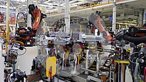 work of robots on a car assembly line, a modern huge factory