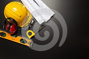 Work safety. Construction site protective equipment on wooden background, flat lay, copy space, top view