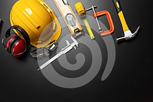 Work safety. Construction site protective equipment on wooden background, flat lay, copy space, top view