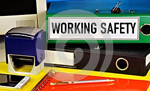 Work safety. Text label on the folder. Monitoring the state of working conditions to reduce injuries and accidents