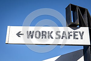 Work Safety. White signpost and blue sky