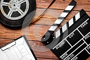 Work screenwriter on wooden background top view