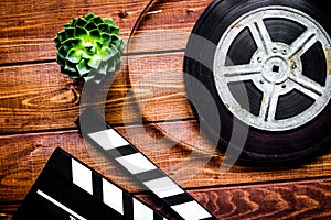 Work screenwriter on wooden background top view