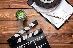 Work screenwriter on wooden background top view