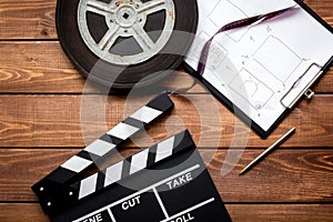 Work screenwriter on wooden background top view