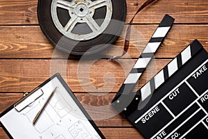 Work screenwriter on wooden background top view