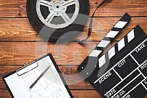 Work screenwriter on wooden background top view